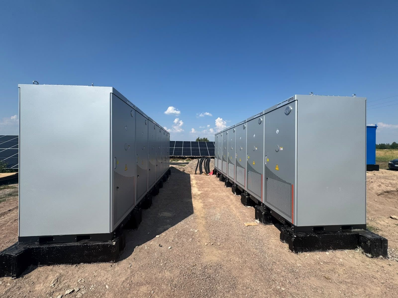 Two rows of battery cabinets at a solar farm